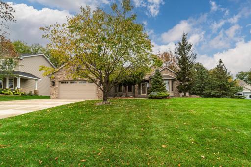 This elegant rambler was built by McDonald Construction and it tucked onto a manicured lot with pond views.