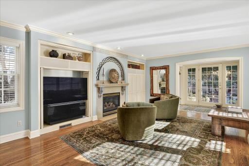 Large family room with built in cabinets and gas fireplace.
