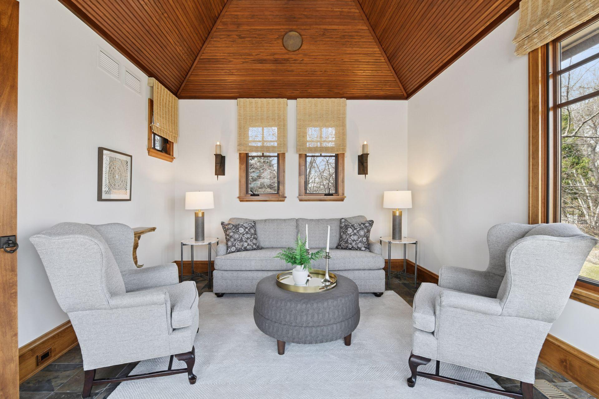 Wood paneled ceiling and walk-out access to the pool and lake beyond