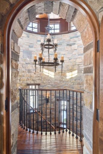 Stunning floor-to-ceiling stonework, leads gracefully up to the bonus room