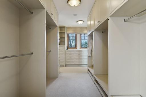 This walk-in closet features a variety of organizational components