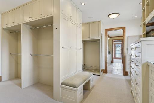 This walk-in closet features a variety of organizational components