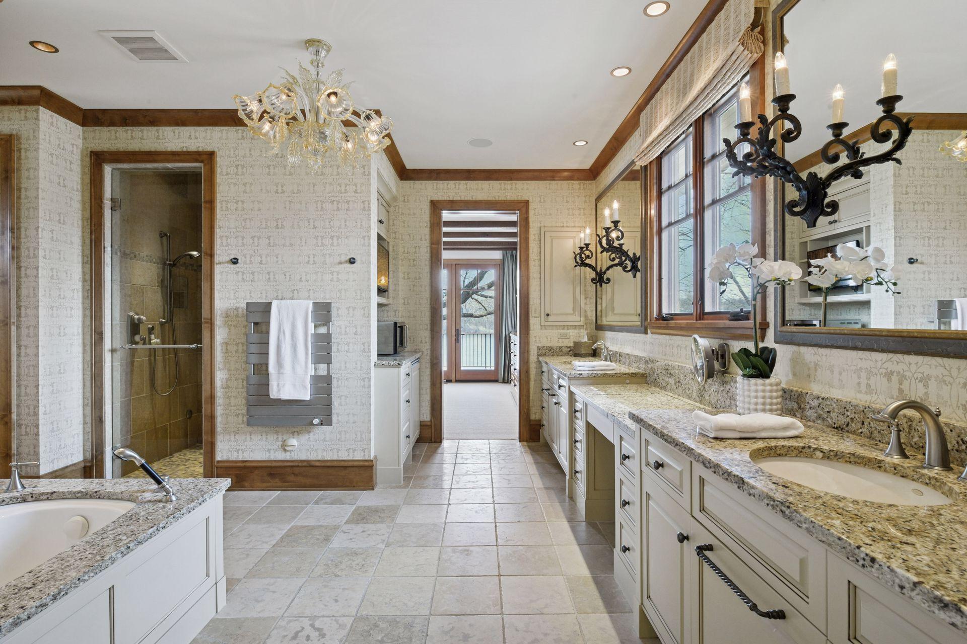 Primary bath with double vanities, whirlpool tub, large walk-in shower, heated floors, plus room for coffee station