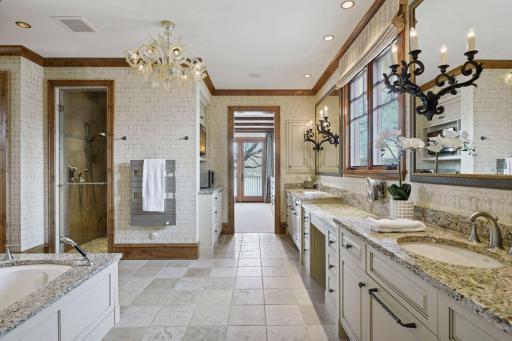 Primary bath with double vanities, whirlpool tub, large walk-in shower, heated floors, plus room for coffee station