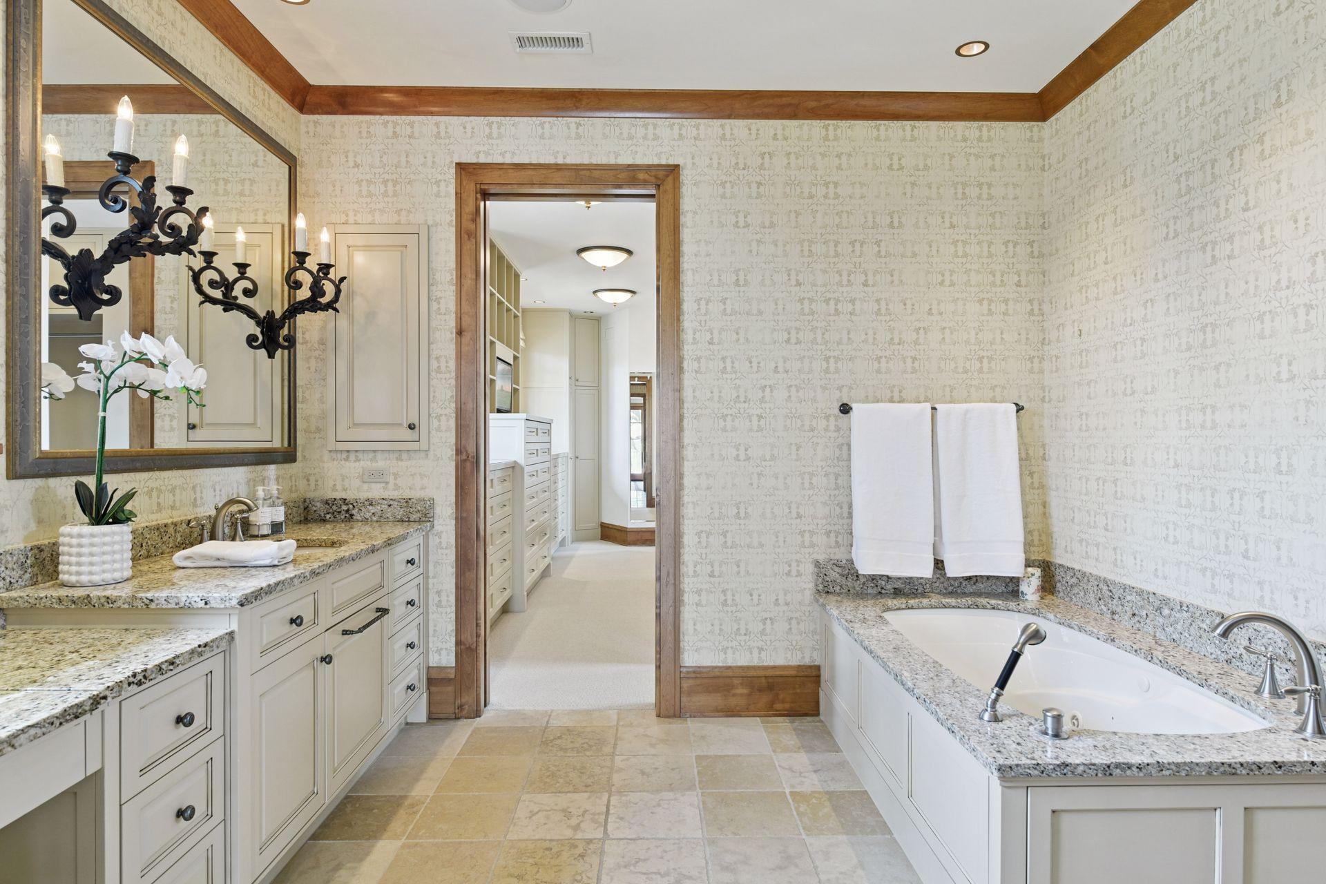 Separate walk-in shower and tub with access to the luxurious walk-in closet