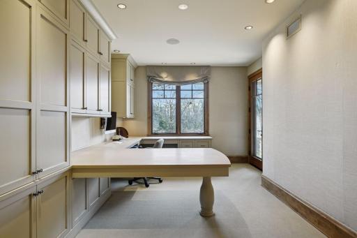 Main floor office #2 with walk-out access to the patio, built-in desk and cabinets; conforming bedroom space