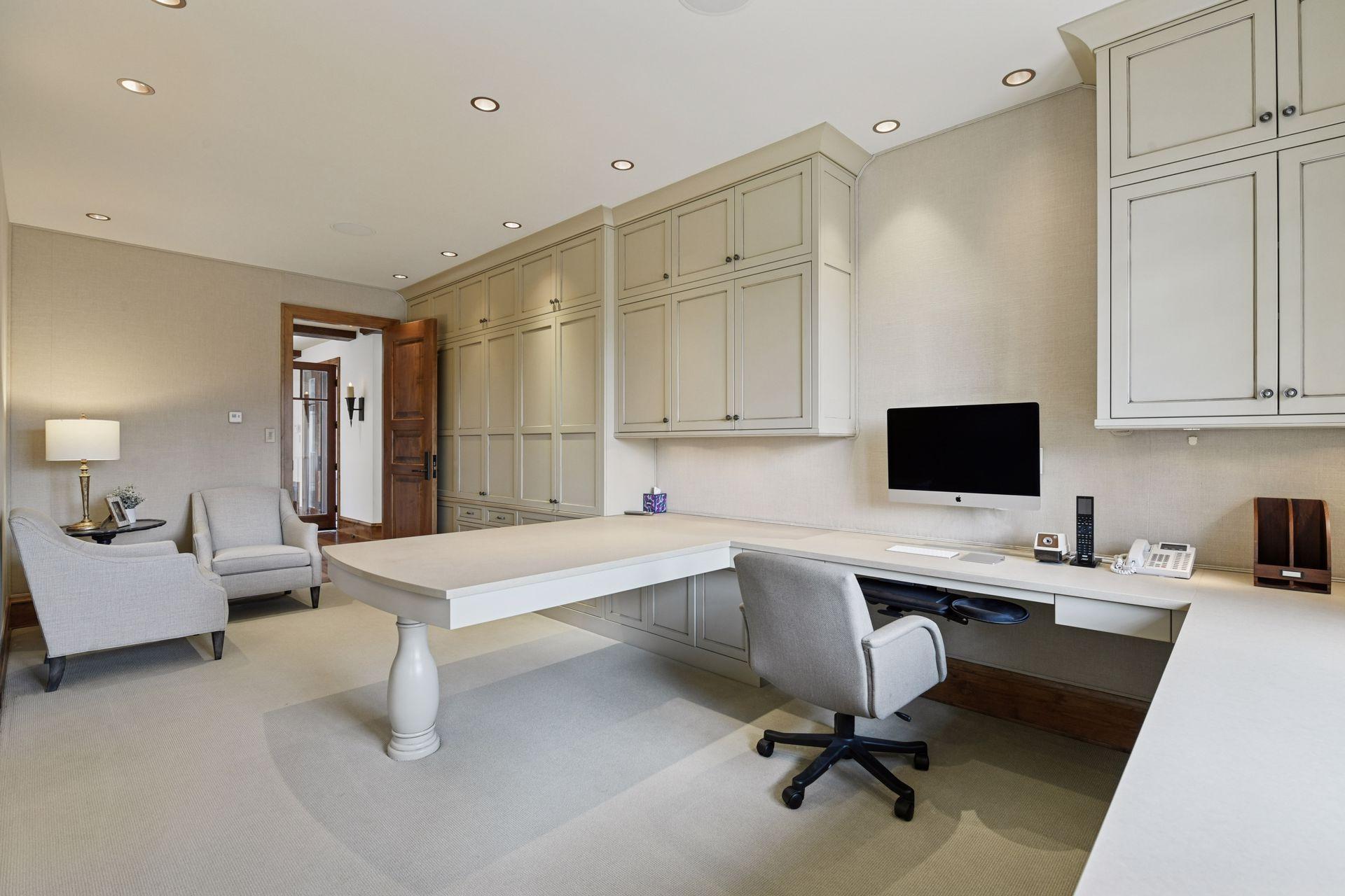 Main floor office #2 with built-in desk and cabinets; conforming bedroom space