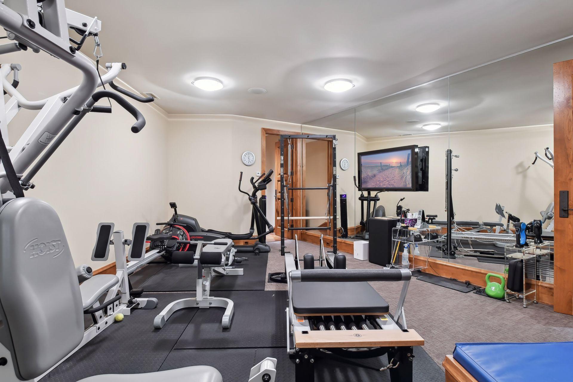 Spacious exercise room with mirrored walls