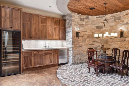 Complete with wine refrigerator and incredible stone work
