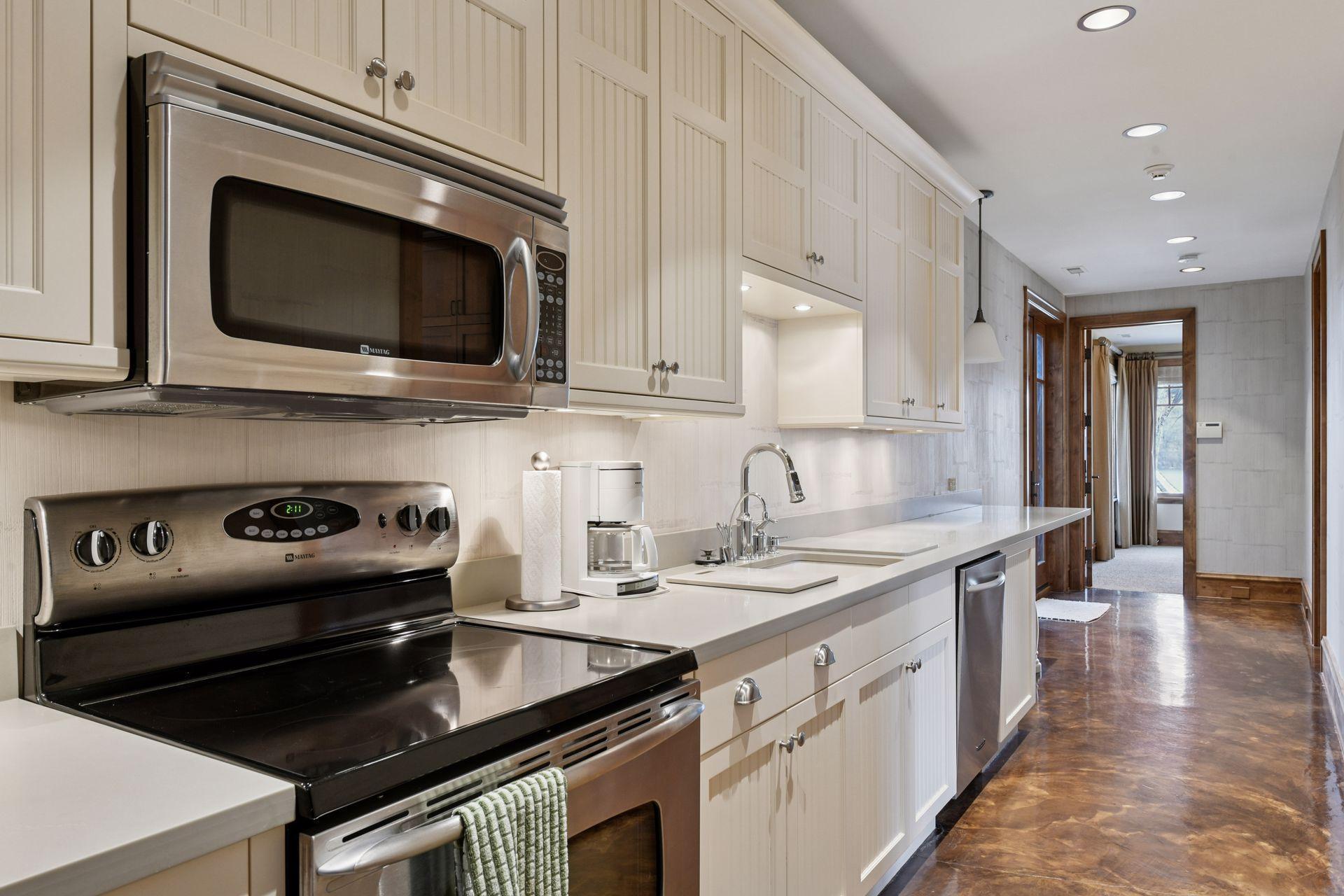 Lower level full kitchen comes in handy when entertaining on this level