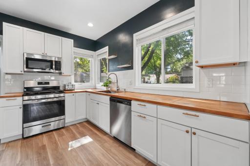East and north-facing windows fill the space with natural light while offering clear sightlines to the deck and backyard