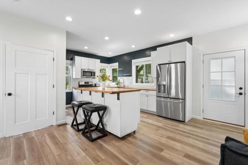 A beautifully appointed kitchen showcases a mobile island that provides flexibility for dining, gathering, and meal preparation