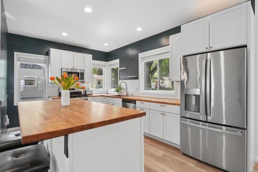 Warm butcher block counters, stainless steel appliances, and exceptional storage create a kitchen that is both stylish and practical