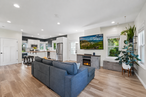 Stunning open-concept living is enhanced by expansive windows that fill the home with natural light