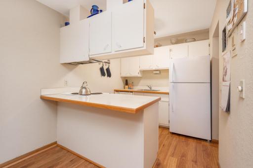 The kitchen has a breakfast bar that is comfortable enough for two chairs for a quick meal on the go.
