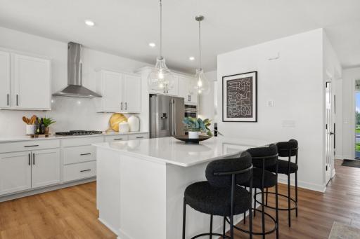 (Photo of model home, finishes will vary) The spacious kitchen naturally serves as the heart of this home, complete with a generous center island, brand-new appliances and a walk-in pantry.