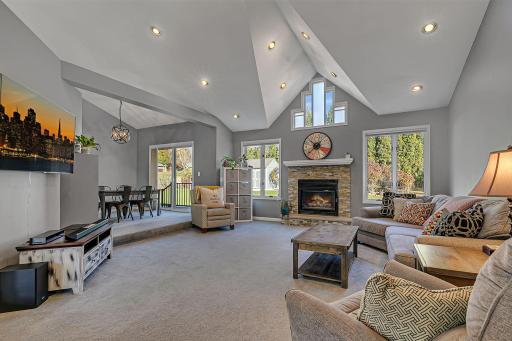 Enjoy The Warmth Of The Fire, Soaring Ceilings And Oversized Windows As you Cozy Up In This Beautiful Living Space!