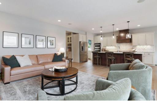 21. Sunlit and spacious, with hardwood floors, custom built-ins, and a dramatic stone fireplace that anchors the space.jpg