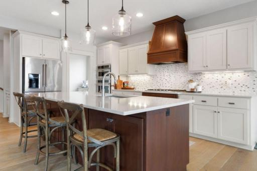 23. Gourmet Kitchen_ Quartz counters, stainless-steel appliances, and an expansive walk-in pantry make this kitchen both functional and beautiful.jpg