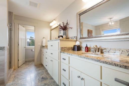 49. Private suite with spa-inspired bath, soaking tub, walk-in shower, and large windows framing serene lake views.jpg