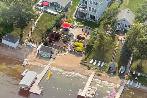 8. Outdoor Living_ Professionally designed outdoor spaces include tiered patios, tiered beach area, fire pit, and built-in audio â all oriented toward the lakeâs sunset.jpg