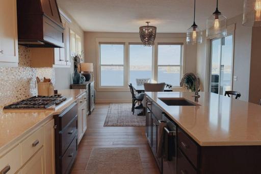 27. Gourmet Kitchen_ Quartz counters, stainless-steel appliances, and an expansive walk-in pantry make this kitchen both functional and beautiful.jpg