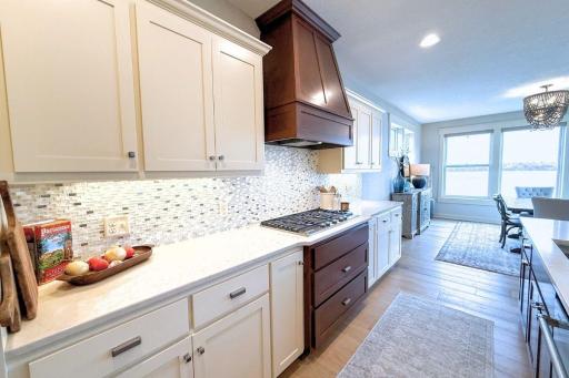25. Gourmet Kitchen_ Quartz counters, stainless-steel appliances, and an expansive walk-in pantry make this kitchen both functional and beautiful.jpg
