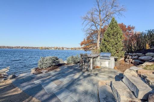 11. Outdoor Living_ Professionally designed outdoor spaces include tiered patios, tiered beach area, fire pit, and built-in audio â all oriented toward the lakeâs sunset.jpg