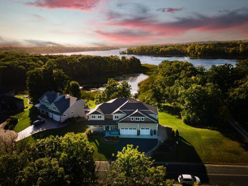 Photo for 18928 Katrine Court, Lakeville, MN 55044 - listing #6814170 Front Elevation Drone image from across the street with lake and pink sky.jpg