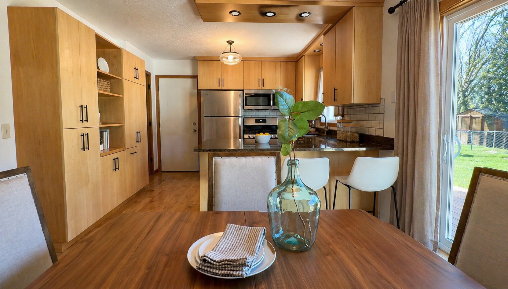Positioned between the living room and kitchen, this space becomes the heart of the home—ideal for gathering, hosting, and staying connected. Thoughtful updates and cohesive finishes create a flow that feels both functional and elevated.