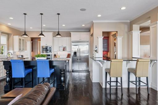 You can easily fit 4 bar stools at the kitchen counter with another 3 at the wet bar