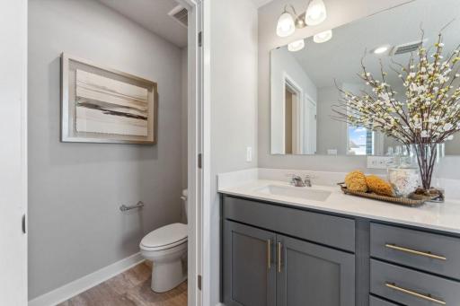 Private water closet in the primary suite. Photo of model home, colors and finishes are similar.