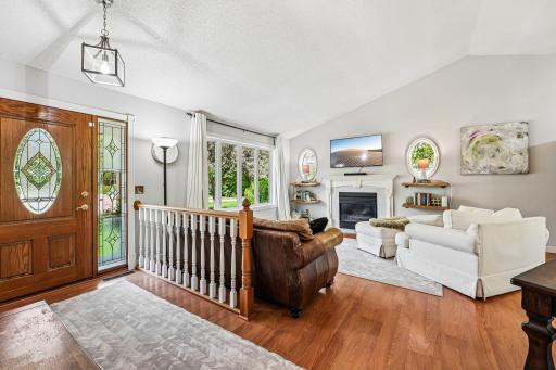 Open and Bright Living Room with Hardwood Flooring and Gas Fireplace
