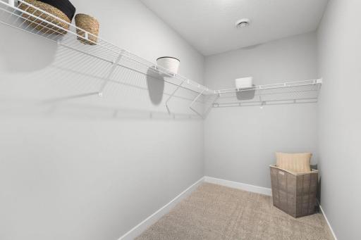 Huge walk-in closet in primary bedroom. Photo of Model home. Colors and options may vary. Ask Sales Agent for details.