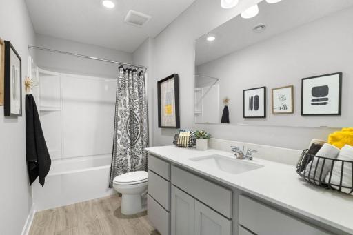 Upper-level hall bath offers a great solution for a busy family. Photo is of model home. Colors and options may vary. Ask Sales Agent for details.