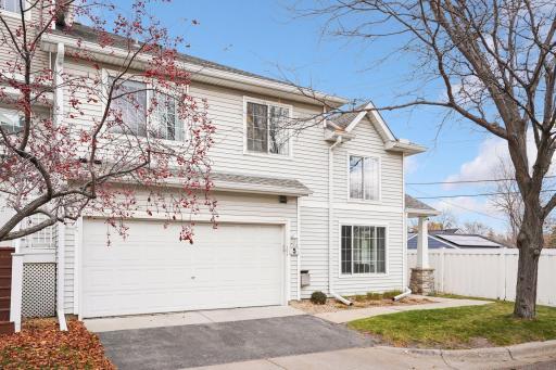 A closer look at the inviting façade featuring updated windows, clean lines, and a quiet setting near guest parking.