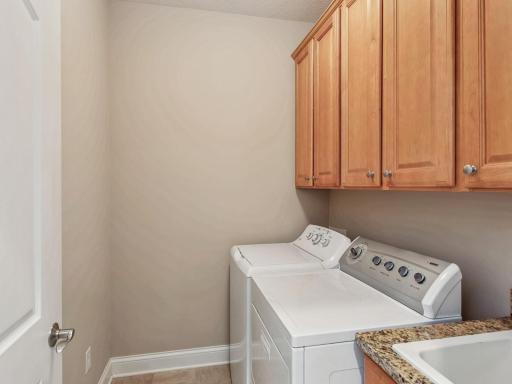 Utility sink and cabinets in laundry room