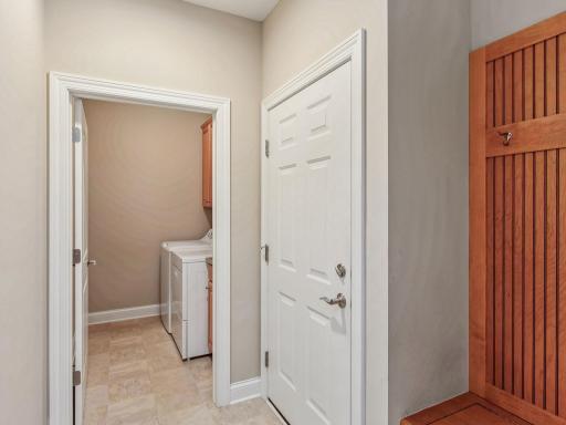 Separate laundry room tucked away off garage