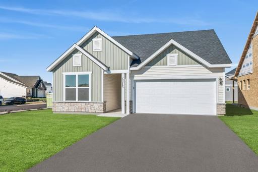 Welcome to the Carmine. Exterior photo of the actual home. Landscaping, mulch, irrigation and sod included. Sod is virtually staged in this photo.