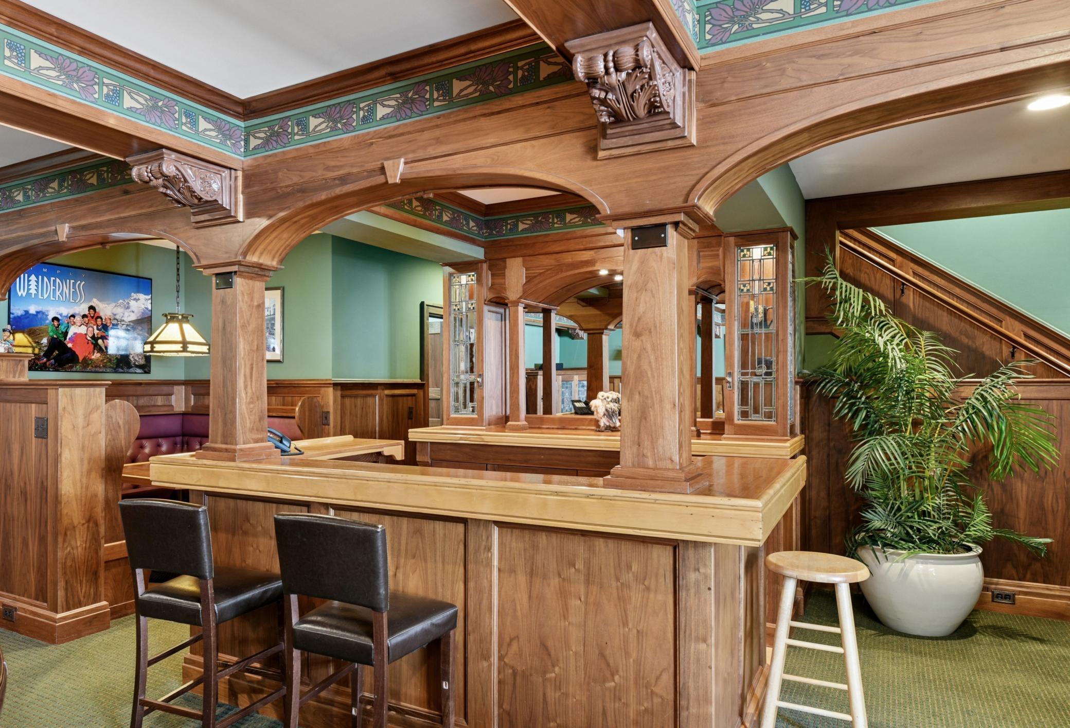 Book match walnut and ribbon grain topped wet bar