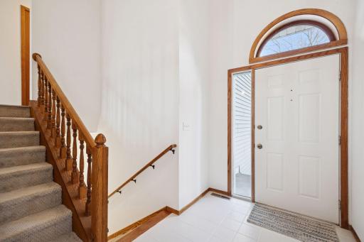 Inviting foyer with natural light and classic wood trim welcomes you into the home.