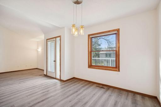 Bright dining area with easy access to the deck and a large window overlooking the backyard.
