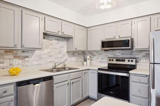 Beautiful backsplash and plenty of cabinet space make this kitchen both stylish and functional.