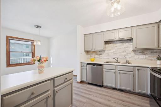 Open kitchen design with a breakfast bar area and great natural light from the adjoining dining space.