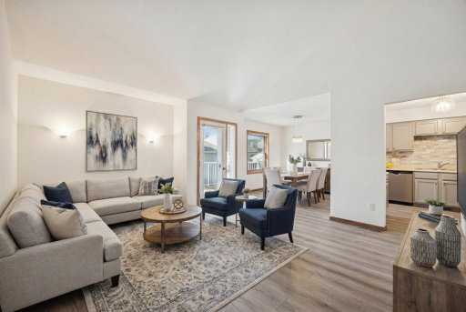 Bright dining space with modern light fixtures, direct access to the deck and plenty of room for gatherings. Virtually staged.