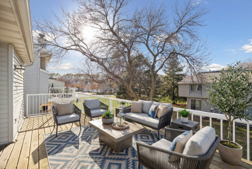 Enjoy the outdoors on the spacious deck - perfect for relaxing or hosting friends, with a nice view of the green yard and trees. Virtually staged.