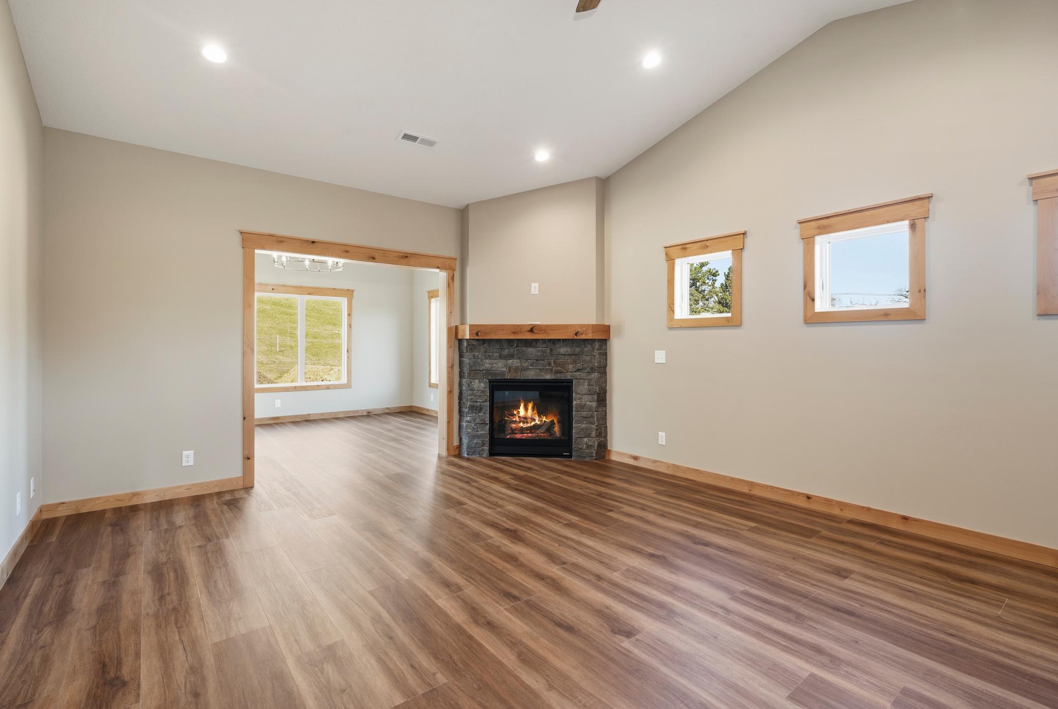 Family Room features LVP flooring, stone fireplace, and a vaulted ceiling!