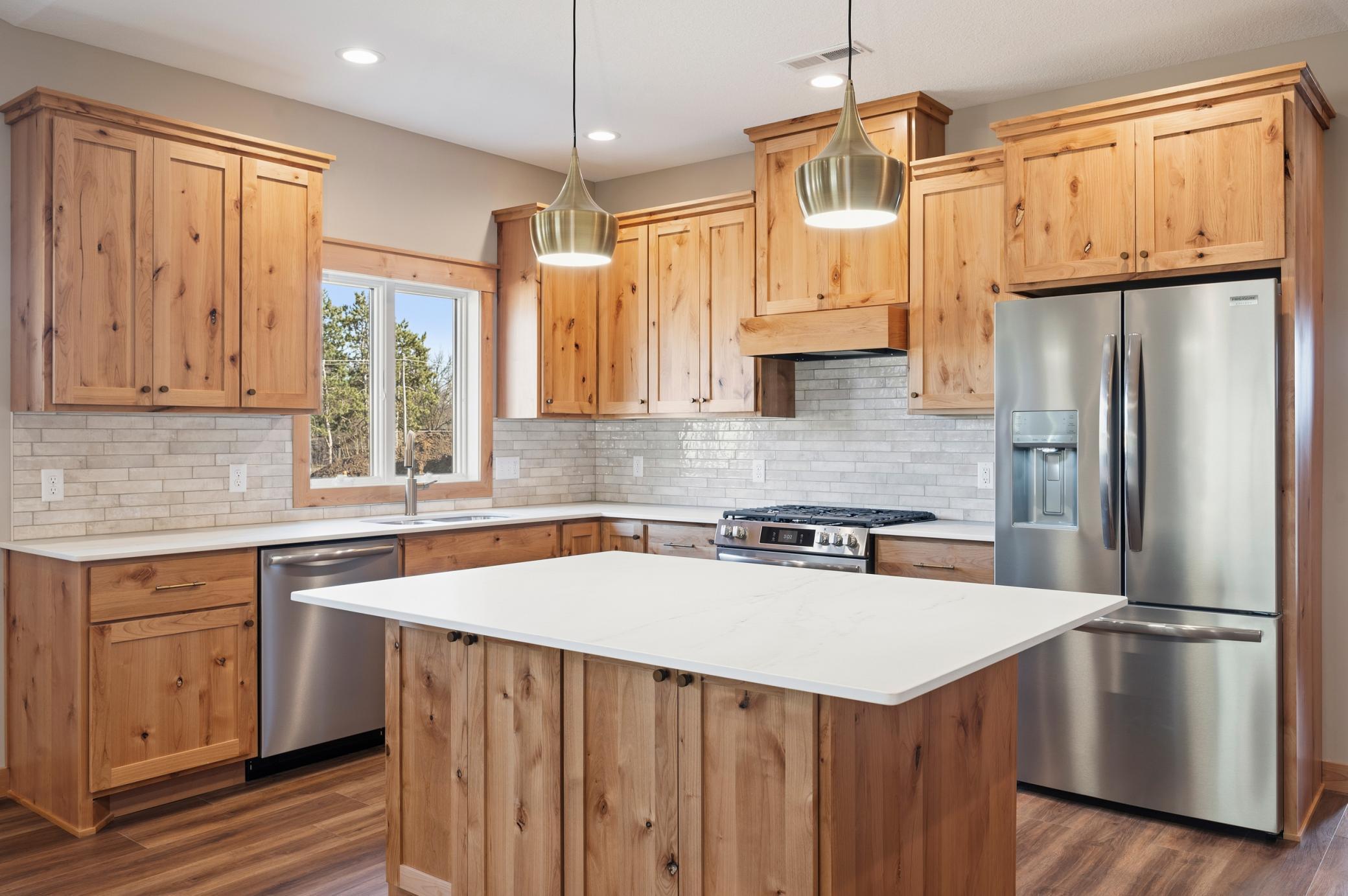Beautiful Kitchen with Tile Backsplash, Under Cabinet Lighting, and Dekton Countertops!