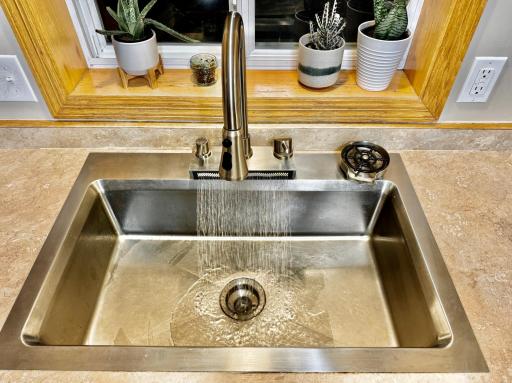 Specialty workstation sink with multiple spraying functions and bottle washer.