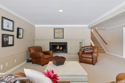 Large family room with a wood burning fireplace.